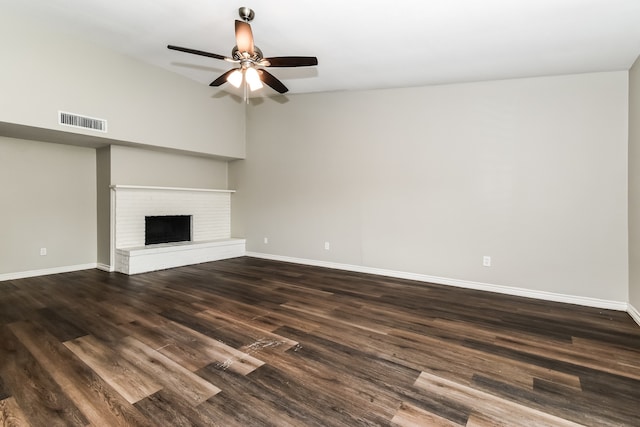 unfurnished living room featuring high vaulted ceiling, a brick fireplace, ceiling fan, and dark hardwood / wood-style floors