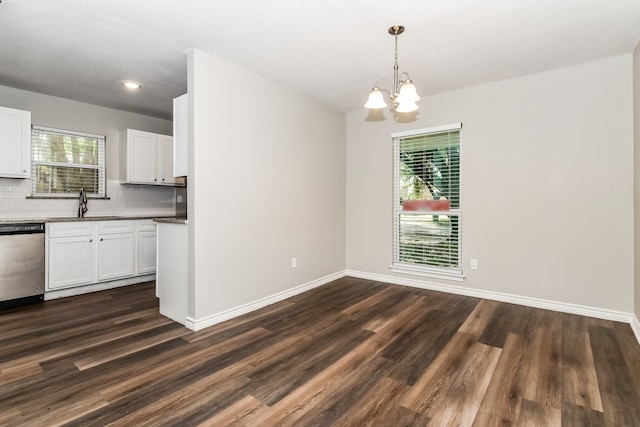 kitchen with dishwasher, white cabinets, tasteful backsplash, and dark hardwood / wood-style floors