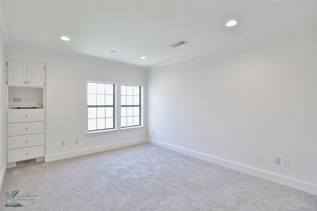 unfurnished bedroom with ornamental molding and light colored carpet