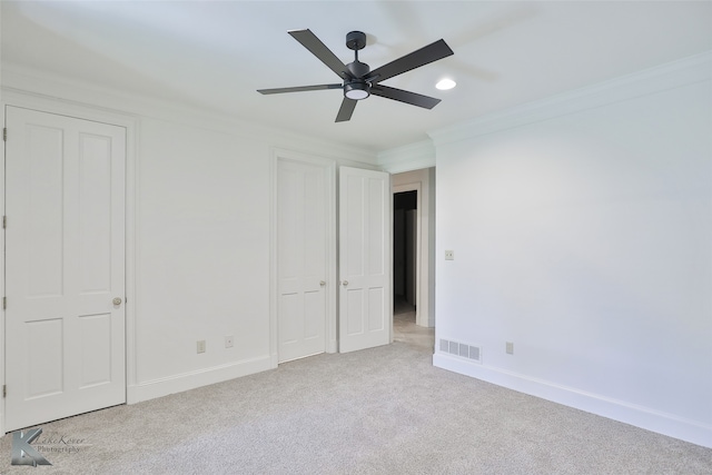 unfurnished bedroom featuring light carpet, ornamental molding, and ceiling fan