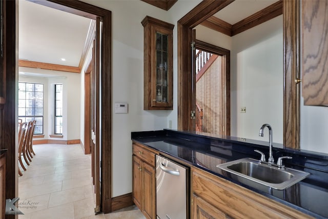 kitchen with crown molding, stainless steel dishwasher, light tile patterned floors, and sink