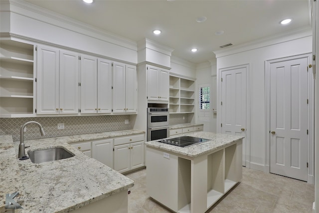 kitchen with sink, tasteful backsplash, light tile patterned flooring, and a center island