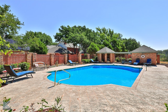 view of swimming pool with a patio