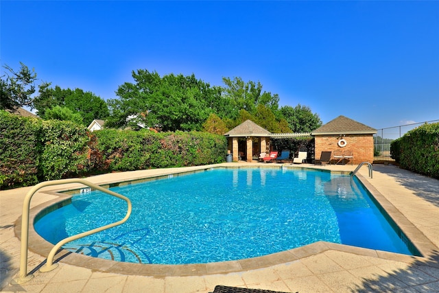 view of swimming pool with a patio area