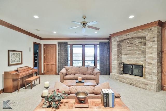 carpeted living room featuring a fireplace, ornamental molding, and ceiling fan