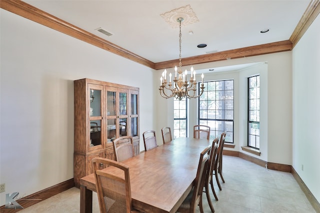 tiled dining space featuring ornamental molding and an inviting chandelier