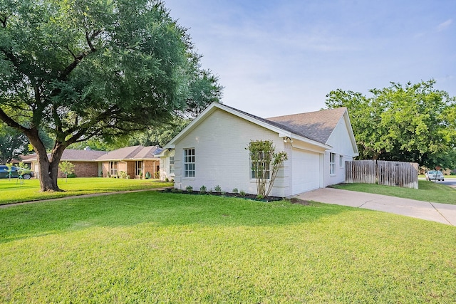 view of front of home featuring a garage and a front lawn