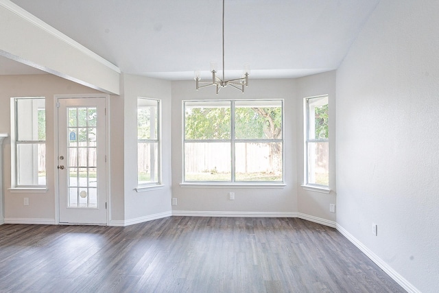 interior space with dark wood-type flooring, a healthy amount of sunlight, and an inviting chandelier