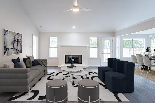 living room with a premium fireplace, hardwood / wood-style floors, ceiling fan, and lofted ceiling