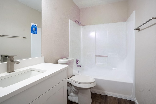 full bathroom with vanity, shower / bath combination, hardwood / wood-style flooring, and toilet