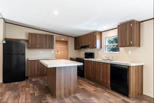 kitchen with dark hardwood / wood-style flooring, a center island, black appliances, and vaulted ceiling