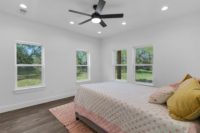 bedroom with dark hardwood / wood-style floors and ceiling fan