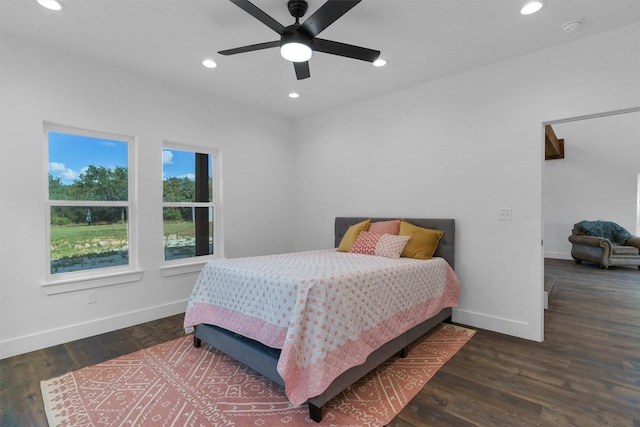 bedroom with ceiling fan and dark hardwood / wood-style flooring