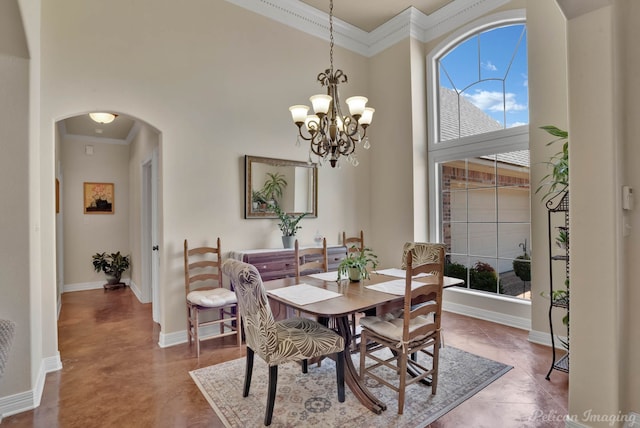 dining area featuring crown molding and a chandelier