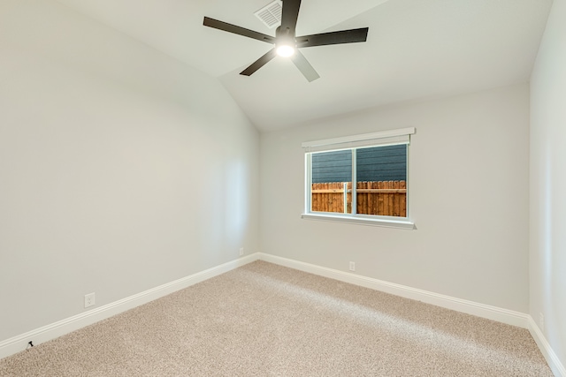 empty room with ceiling fan, carpet flooring, and vaulted ceiling