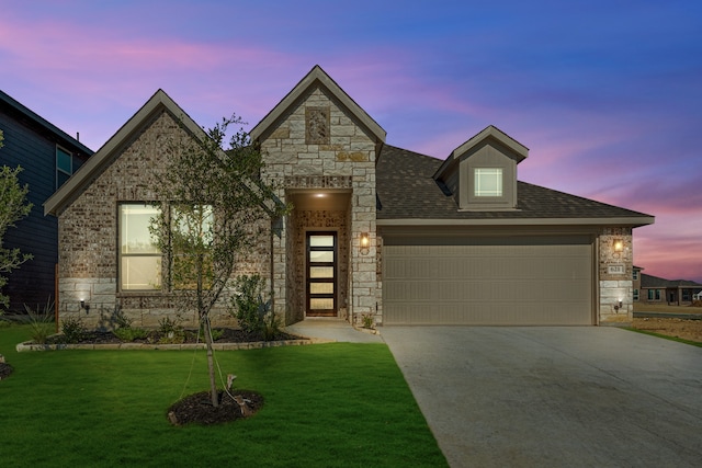 view of front of property with a lawn and a garage