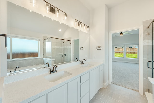 bathroom with tile patterned flooring, plus walk in shower, ceiling fan, and double vanity