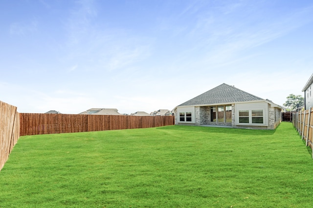 rear view of property with a yard