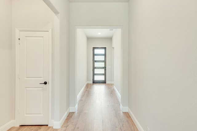 hall with light hardwood / wood-style flooring