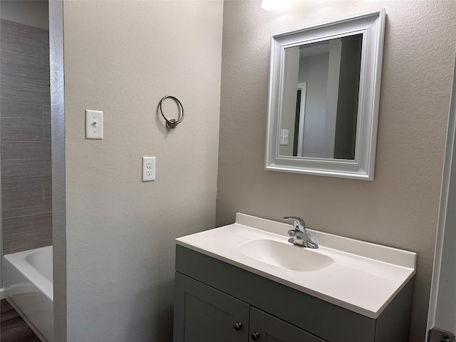 bathroom with a bathing tub and vanity