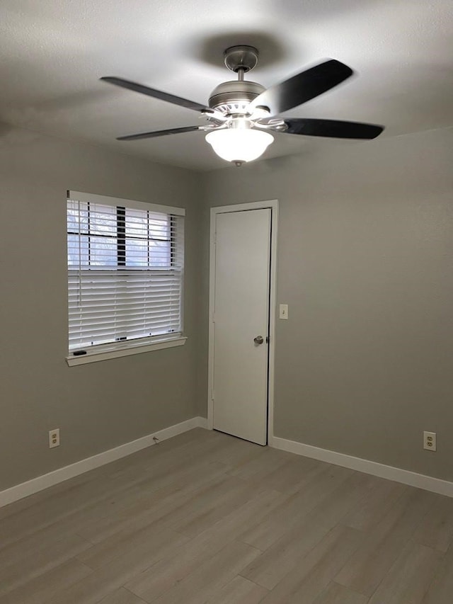 unfurnished room with ceiling fan and light hardwood / wood-style floors