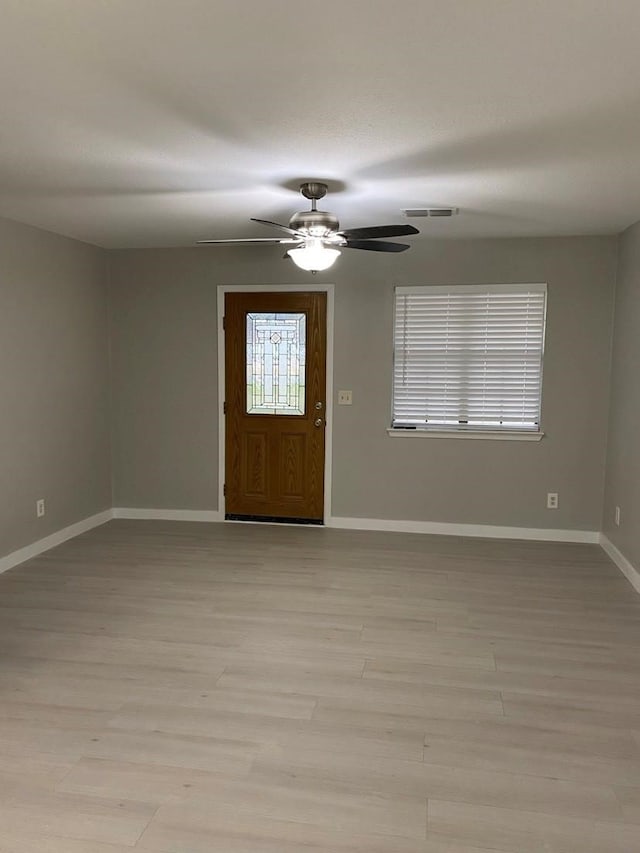 foyer entrance with light hardwood / wood-style floors and ceiling fan