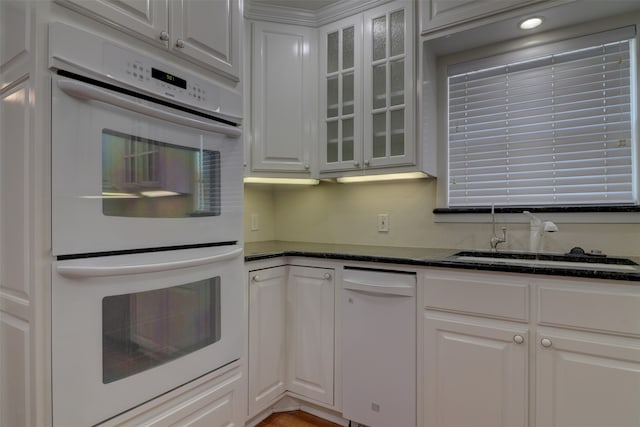 kitchen featuring white appliances and white cabinetry