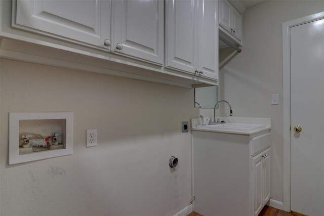 laundry room with washer hookup, sink, wood-type flooring, cabinets, and electric dryer hookup