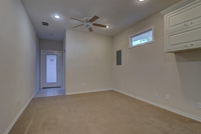 carpeted spare room with ceiling fan and electric panel