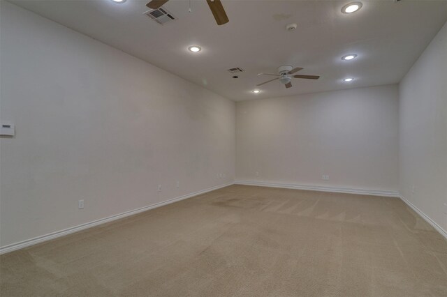 carpeted spare room with ceiling fan