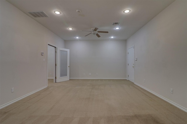 empty room with light carpet, a ceiling fan, visible vents, and recessed lighting