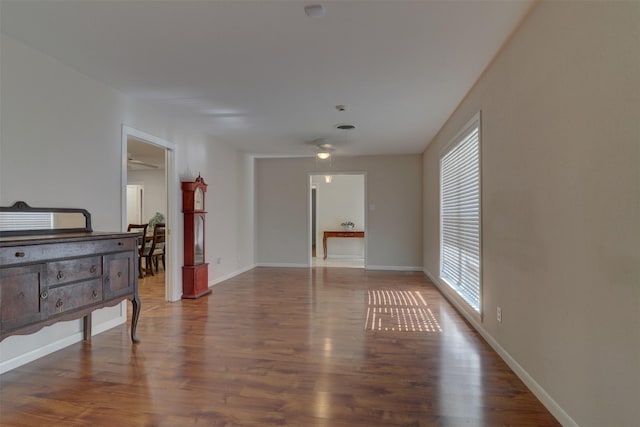 spare room featuring wood finished floors and baseboards