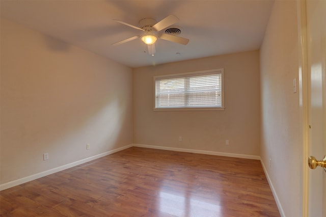 spare room with ceiling fan and hardwood / wood-style flooring