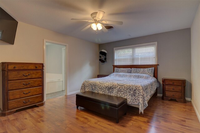 bedroom with connected bathroom, ceiling fan, and light hardwood / wood-style flooring