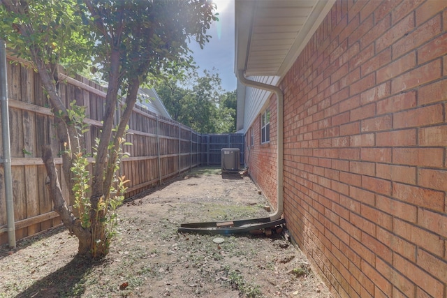 view of yard featuring a fenced backyard and central air condition unit