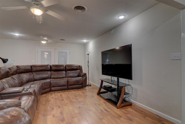 living room featuring ceiling fan and light hardwood / wood-style flooring