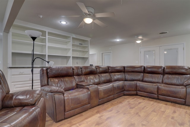 living room featuring light hardwood / wood-style floors and ceiling fan