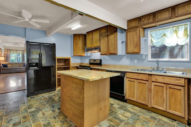 kitchen featuring ceiling fan, sink, beamed ceiling, a kitchen island, and black appliances