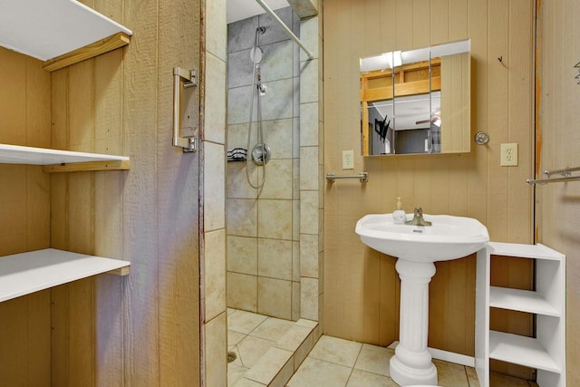 bathroom with tile patterned floors and tiled shower