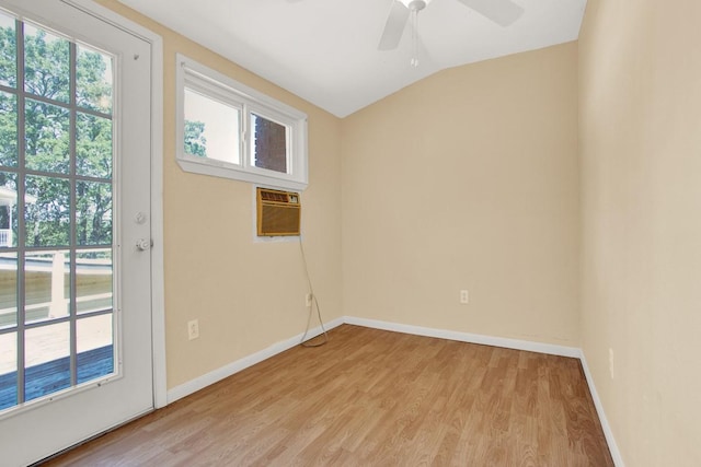 unfurnished room with an AC wall unit, ceiling fan, light hardwood / wood-style floors, and vaulted ceiling