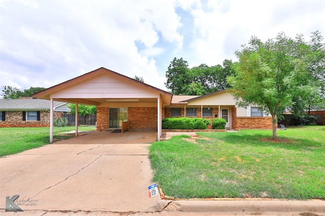 single story home featuring a carport and a front lawn