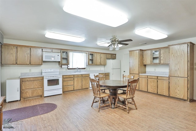 kitchen with ceiling fan, sink, white appliances, and light hardwood / wood-style flooring