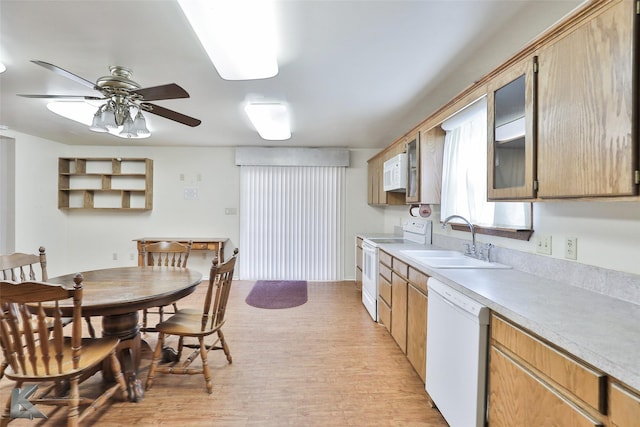 kitchen with ceiling fan, sink, white appliances, and light hardwood / wood-style flooring