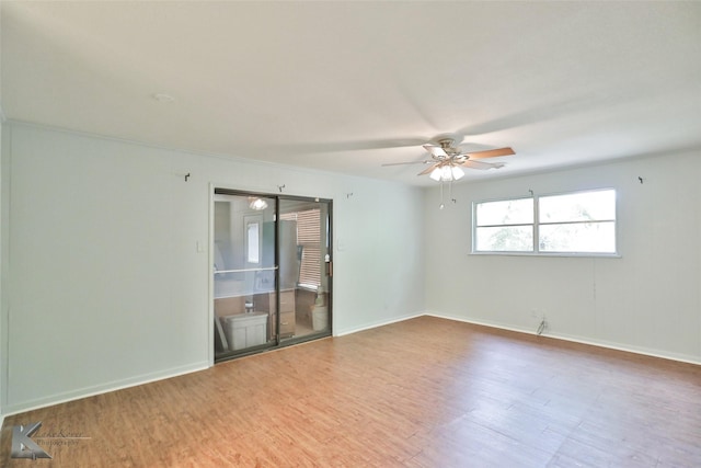 empty room with hardwood / wood-style floors, ceiling fan, and ornamental molding