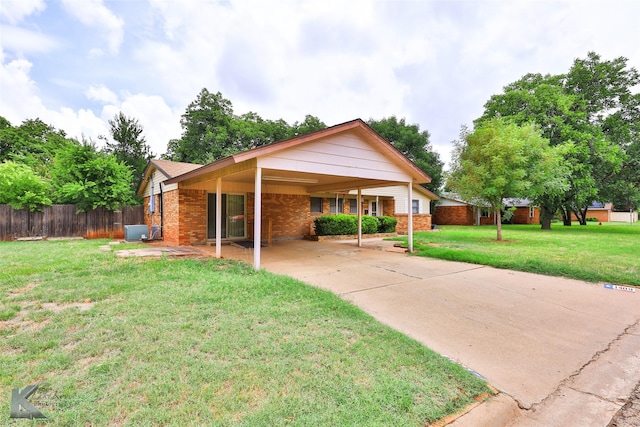 view of front of home with a front lawn and a carport