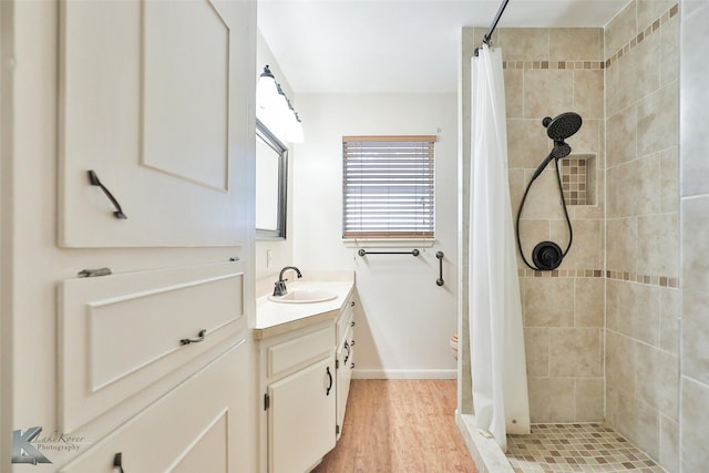 bathroom with curtained shower, vanity, and hardwood / wood-style flooring