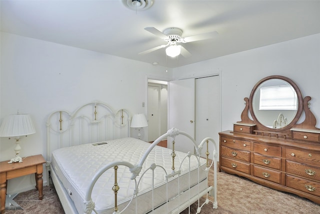 carpeted bedroom featuring ceiling fan and a closet