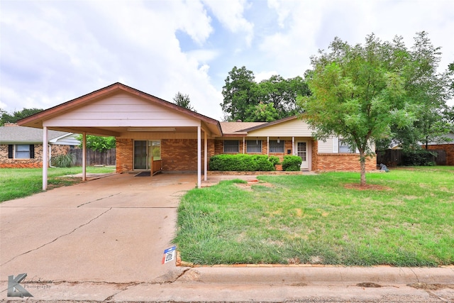 ranch-style home with a front yard and a carport