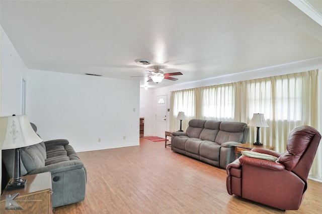 living room featuring ceiling fan and light hardwood / wood-style flooring