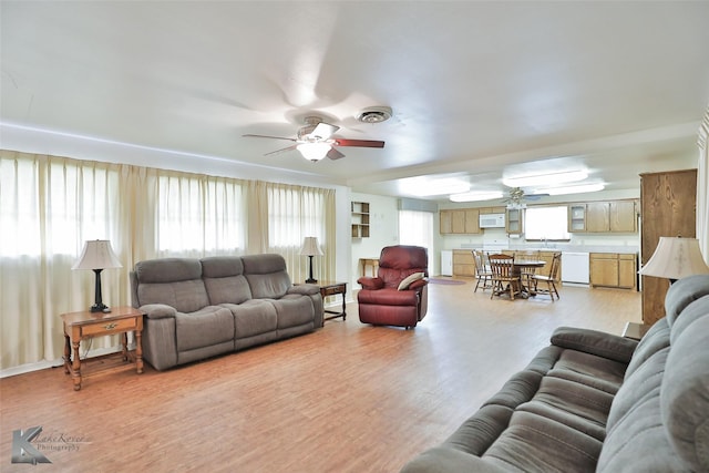 living room with ceiling fan and light hardwood / wood-style floors